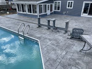 a stamped concrete pool deck,patio, and driveway installed by Metric Concrete Sewell, NJ